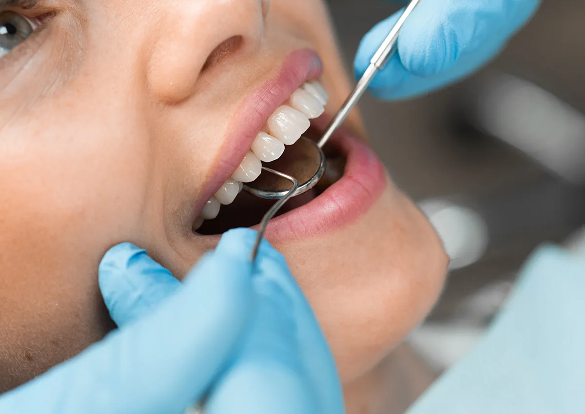 Dentist looking in a patients mouth to perform dentistry treatment 