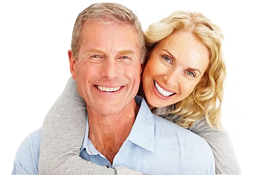 Older couple smiling with dental implants